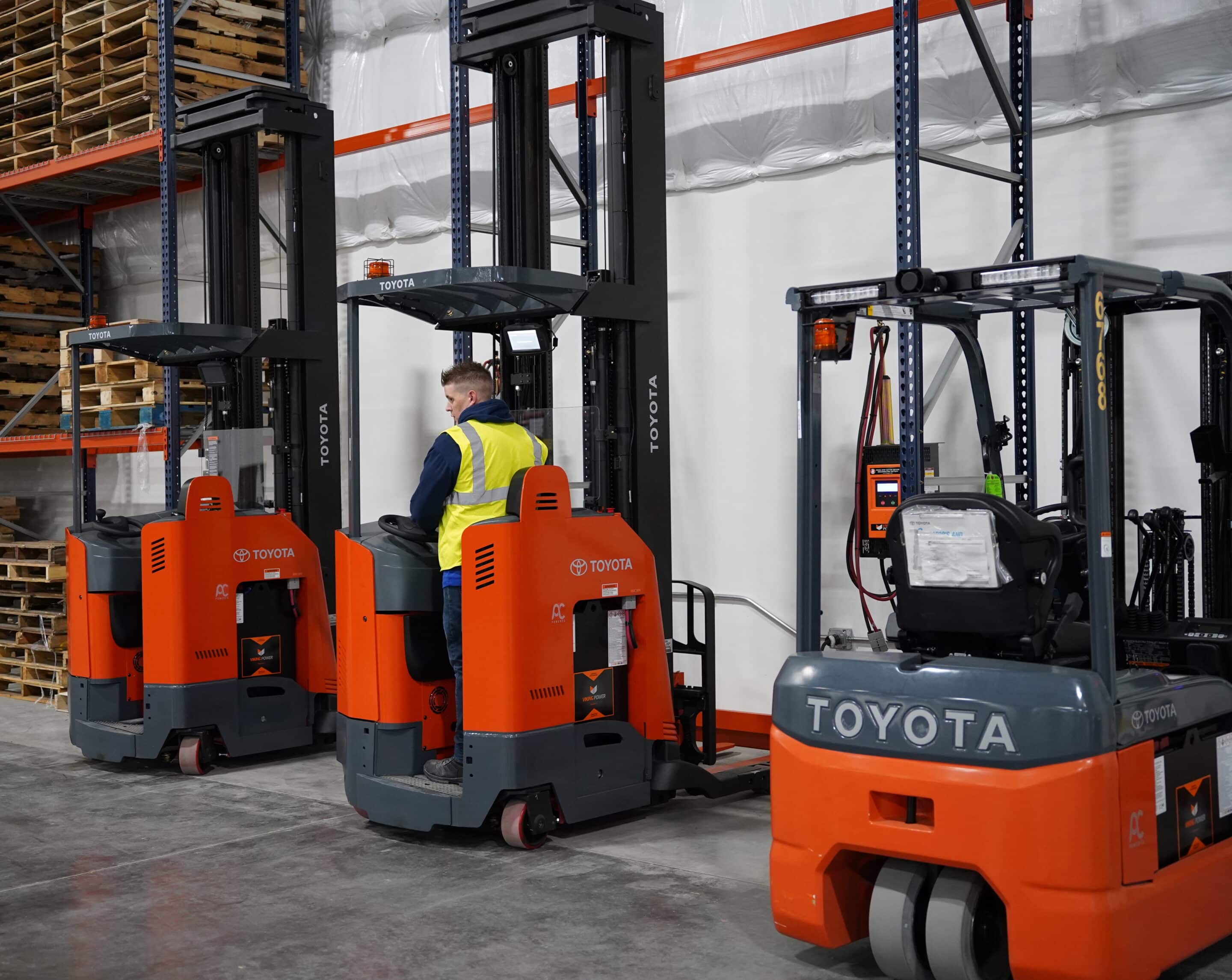Man on forklift in warehouse.
