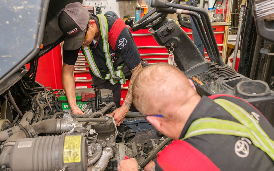 Two Shoppa's forklift technicians working on a lift truck